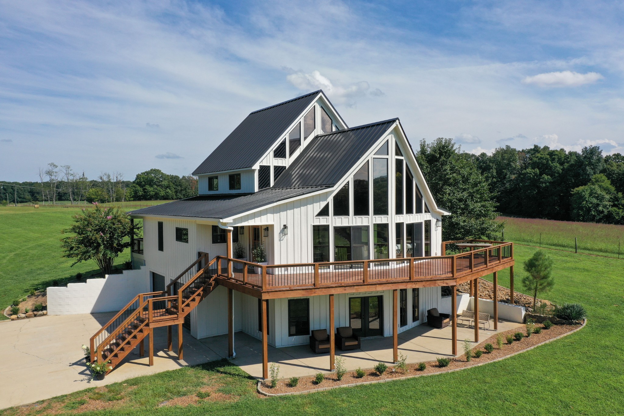 7720 Smith Road Primm Springs, TN 38476 - Photo 4 of 58 a front view of a house with a yard table and chairs