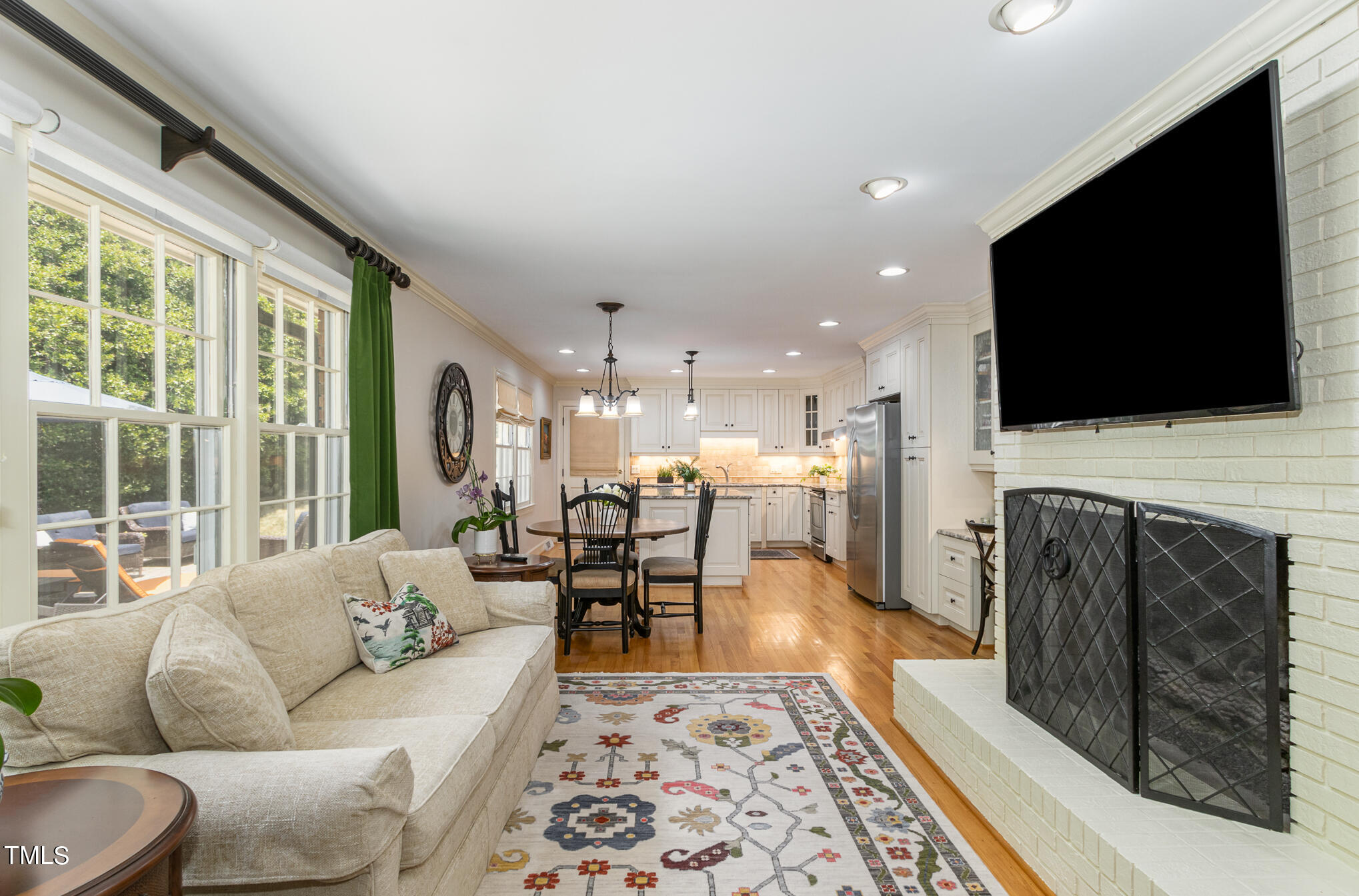 2901 Augusta Court Raleigh, NC 27607 - Photo 14 of 28 a living room with fireplace furniture and a flat screen tv