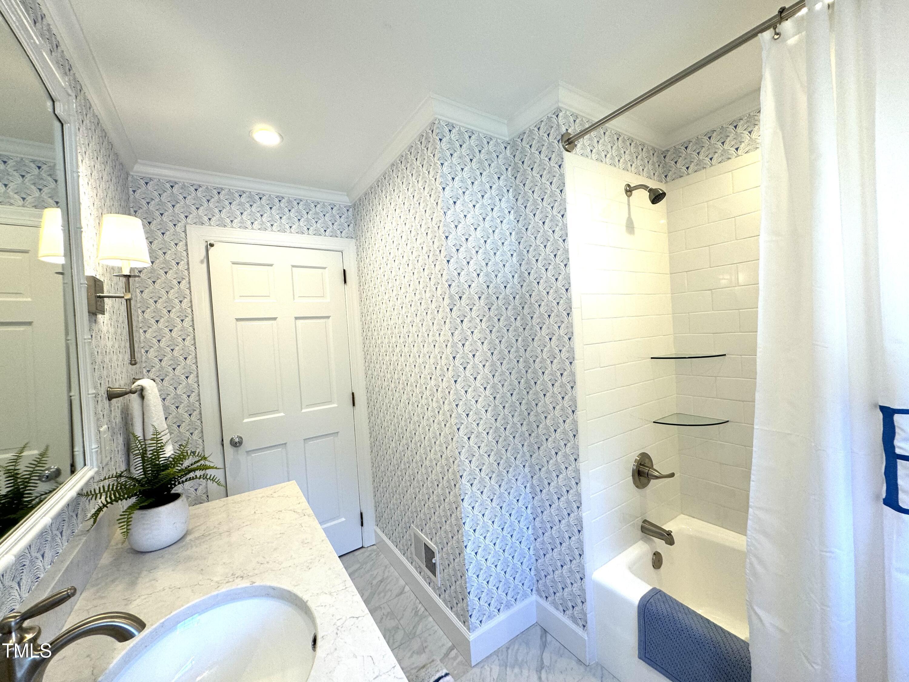 2901 Augusta Court Raleigh, NC 27607 - Photo 16 of 28 a bathroom with a tub shower and sink