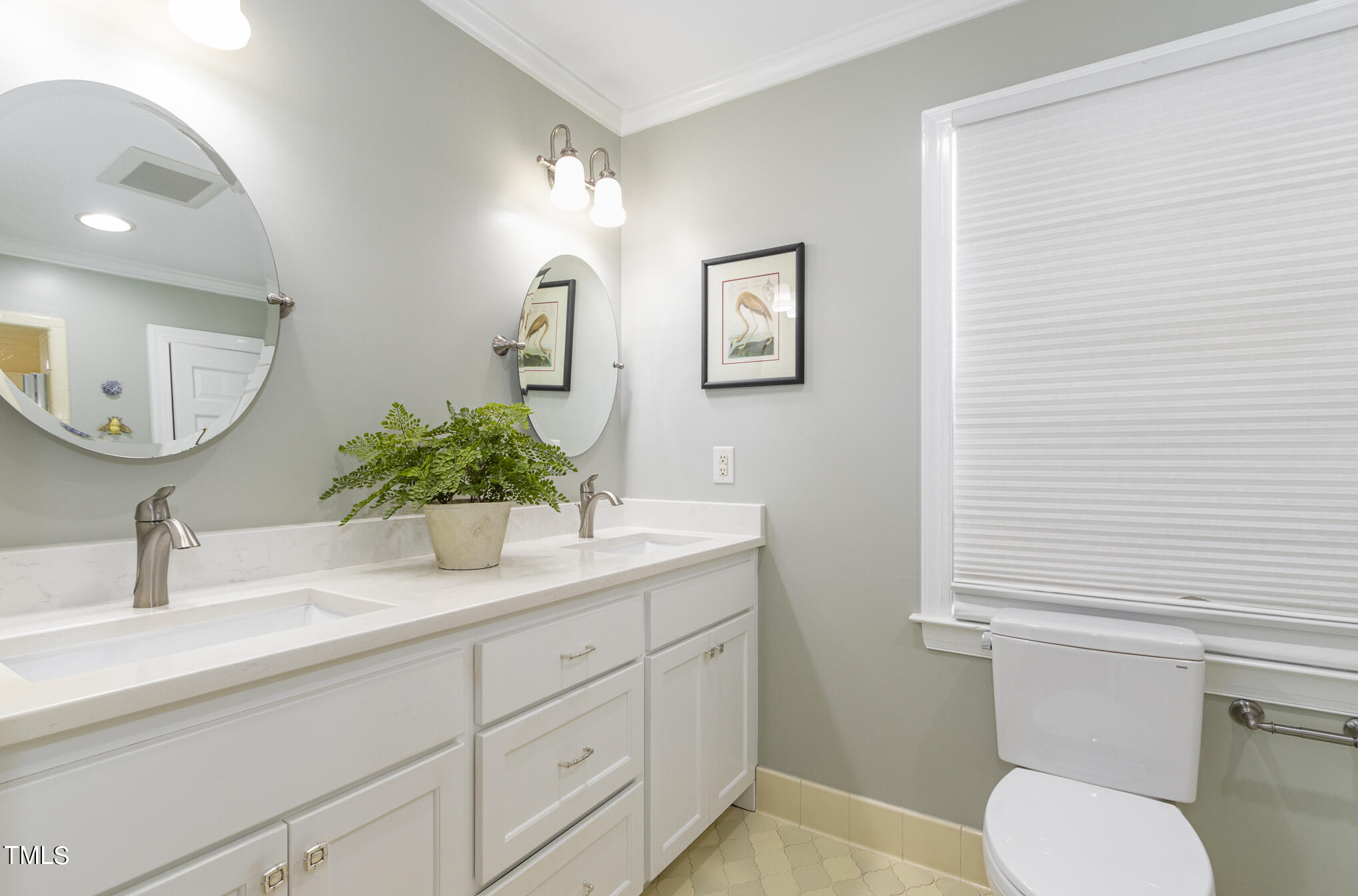 2901 Augusta Court Raleigh, NC 27607 - Photo 18 of 28 a bathroom with a toilet a sink and mirror