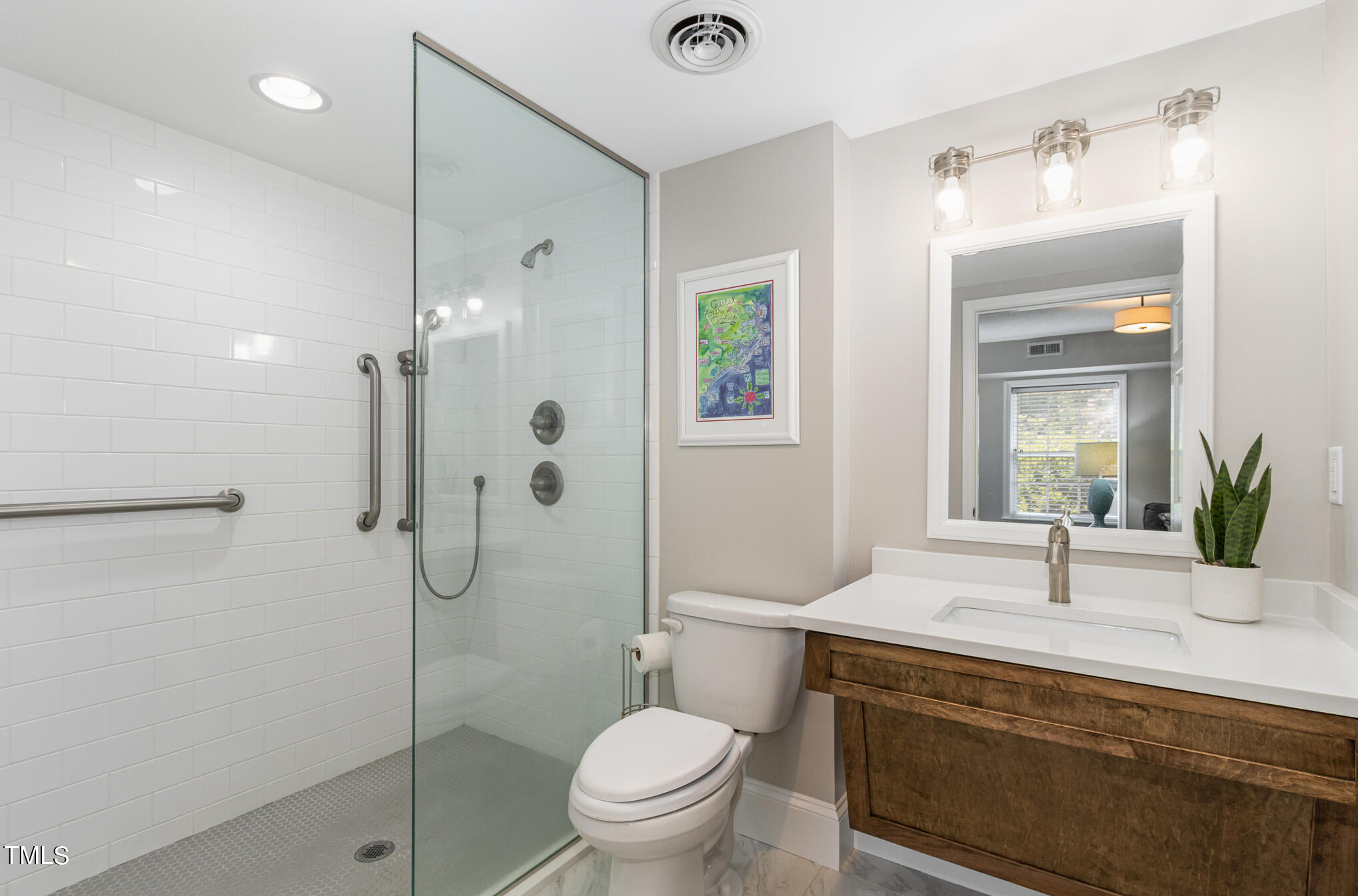 2901 Augusta Court Raleigh, NC 27607 - Photo 20 of 28 a bathroom with a sink a toilet and shower
