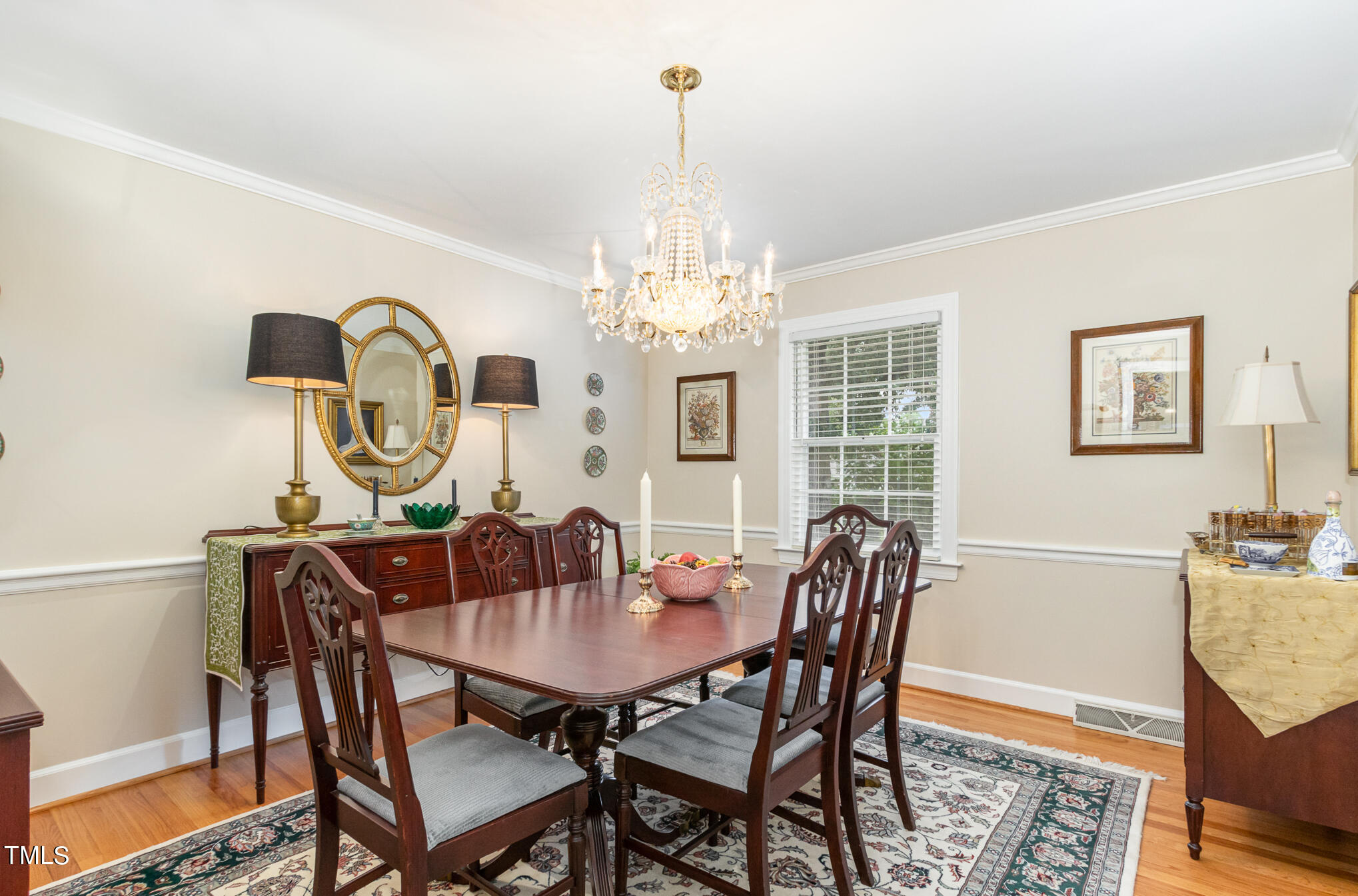 2901 Augusta Court Raleigh, NC 27607 - Photo 9 of 28 a dining room with furniture a chandelier and wooden floor