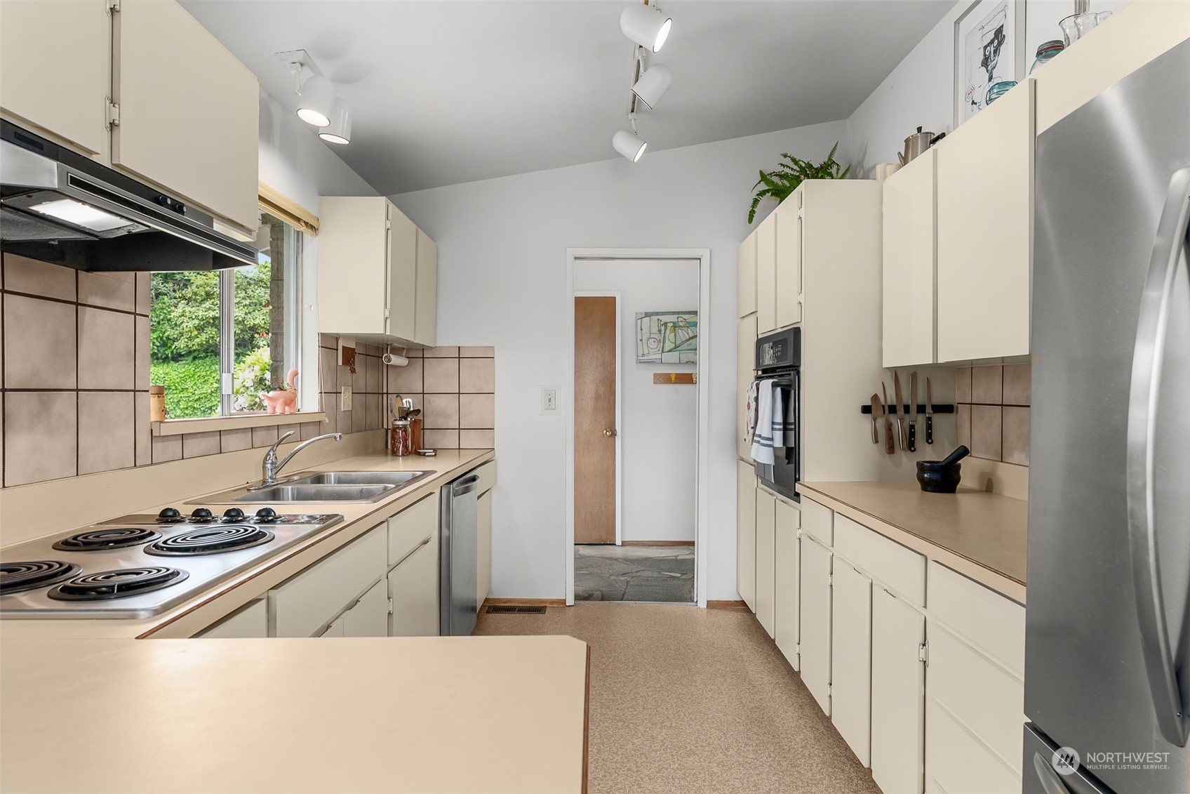 2520 South Raymond Street Seattle, WA 98108 - Photo 8 of 39 a kitchen with stainless steel appliances a sink a stove a refrigerator and window