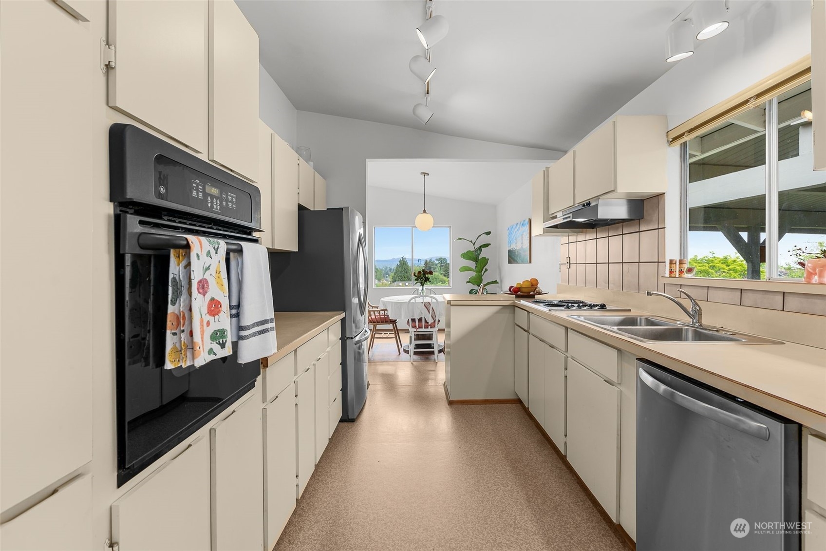 2520 South Raymond Street Seattle, WA 98108 - Photo 9 of 39 a kitchen with stainless steel appliances a sink dishwasher stove refrigerator and cabinets