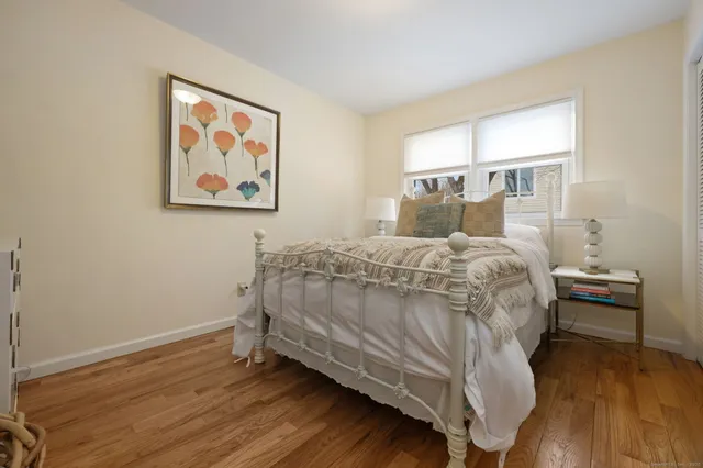 a bed sitting in a bedroom next to a window