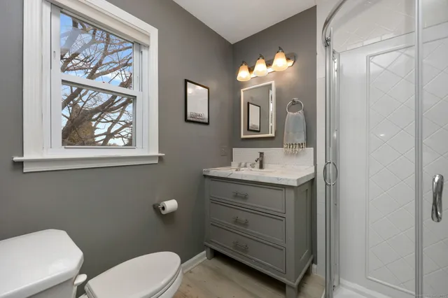 a bathroom with a toilet sink and mirror