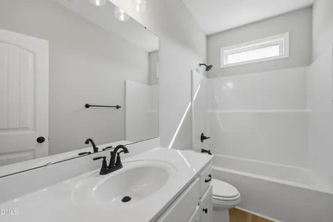 a bathroom with a sink a toilet and a bathtub