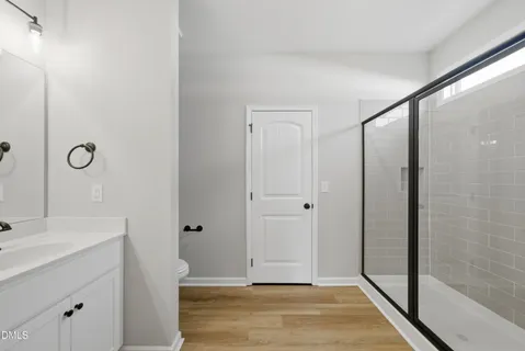a bathroom with a glass shower door