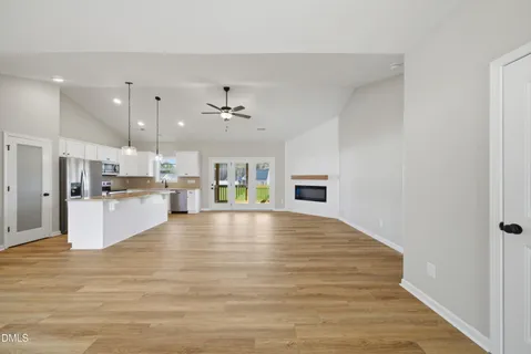 a view of a room with wooden floor and a window