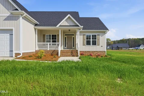 a view of a house with a yard and plants