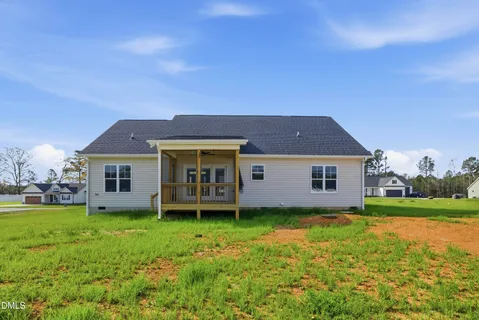 a view of house with a big yard