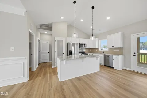 a kitchen with white cabinets and white appliances