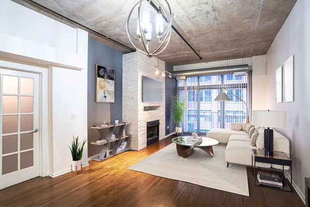 a living room with furniture a fireplace and a table
