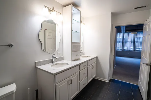 a bathroom with a double vanity sink and mirror