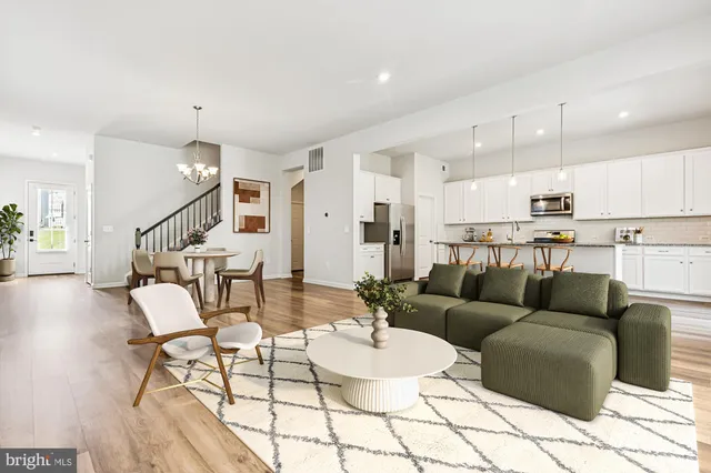 a living room with furniture and kitchen view