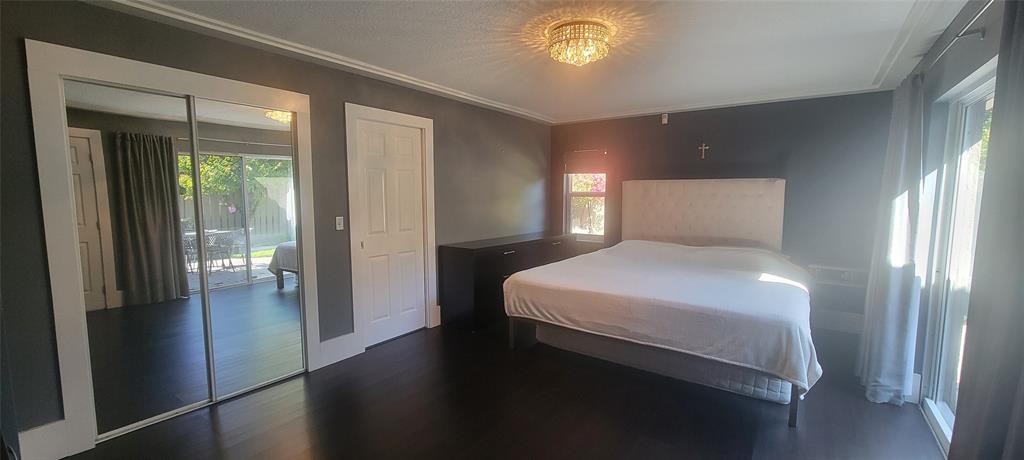 12555 Southwest 7th Place Davie, FL 33325 - Photo 14 of 34 a bedroom with a bed and a lamp on table