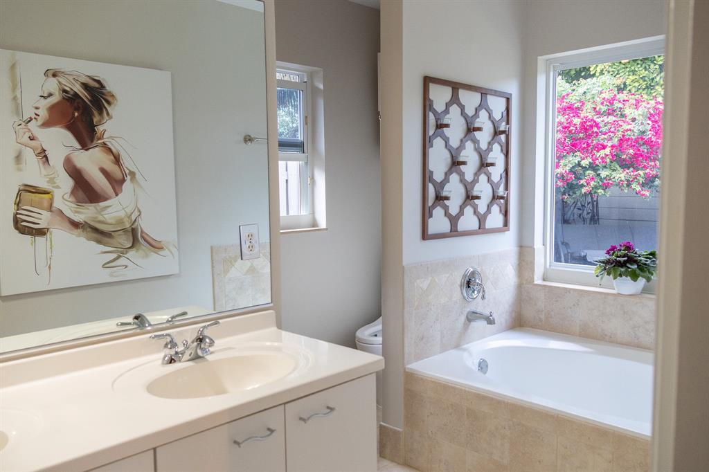 12555 Southwest 7th Place Davie, FL 33325 - Photo 18 of 34 a bathroom with a sink mirror and a bathtub