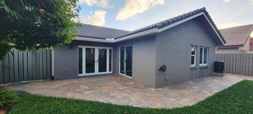 12555 Southwest 7th Place Davie, FL 33325 - Photo 30 of 34 a view of backyard with large trees and wooden fence