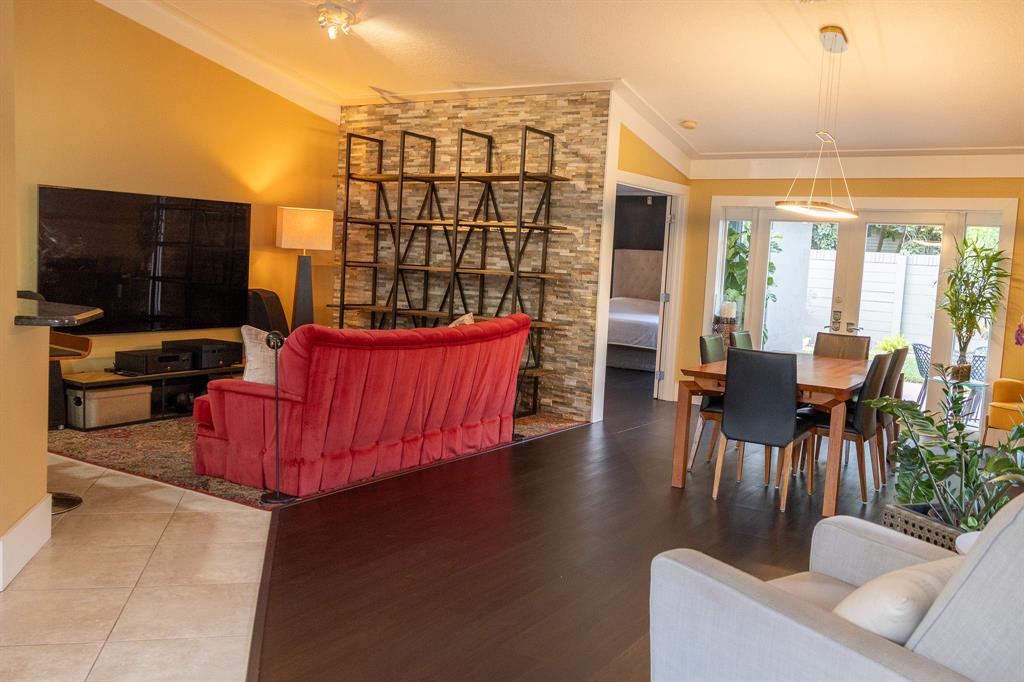 12555 Southwest 7th Place Davie, FL 33325 - Photo 6 of 34 a living room with furniture a flat screen tv and kitchen view