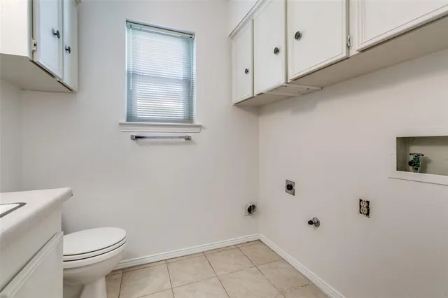 a view of a backyard with large trees and wooden fence