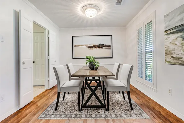a dining room with furniture wooden floor and a rug