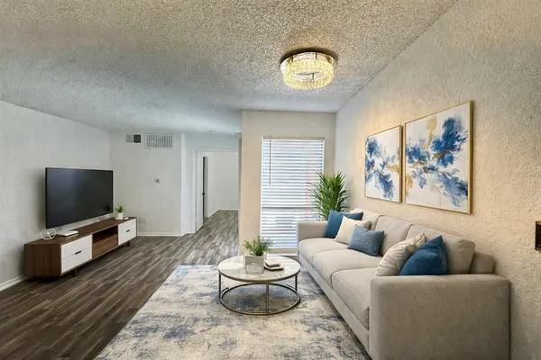 a living room with furniture and a flat screen tv