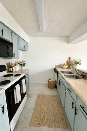a kitchen with a sink stove and cabinets