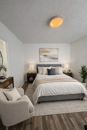 a bedroom with bed and flowerpot