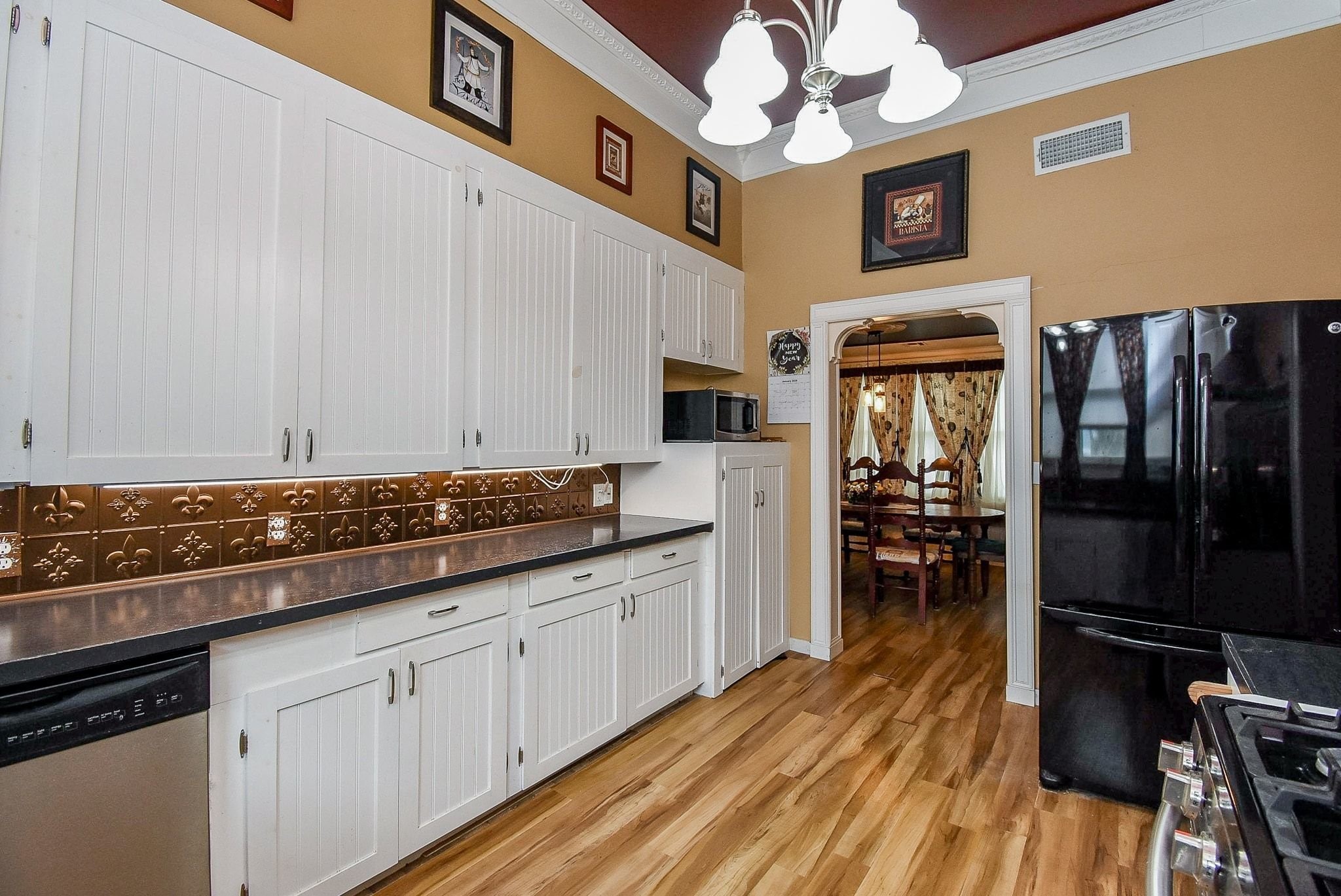 807 Clipson Road Eagle Lake, TX 77434 - Photo 12 of 31 a kitchen with granite countertop cabinets stainless steel appliances and a wooden floor