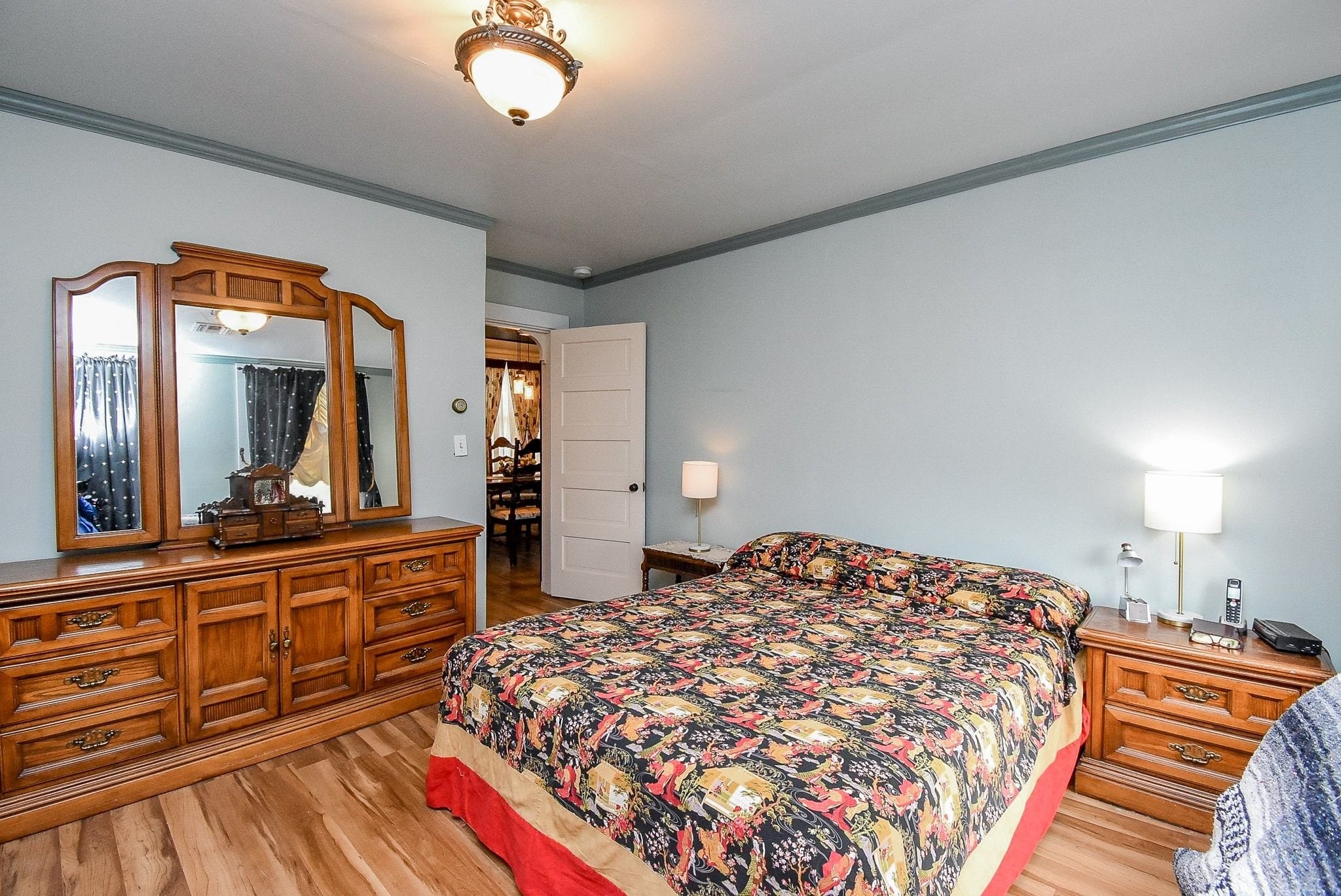 807 Clipson Road Eagle Lake, TX 77434 - Photo 17 of 31 a bedroom with a large bed and a large mirror on the dresser