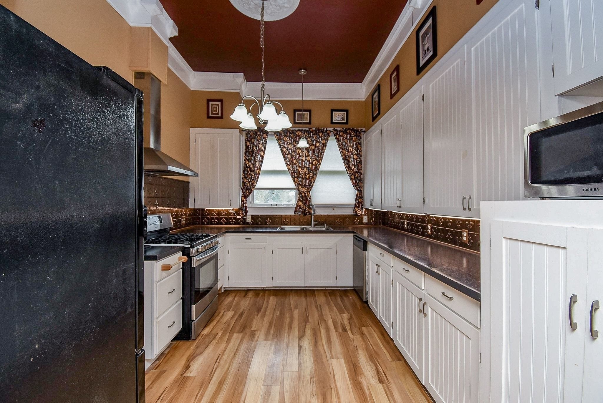 807 Clipson Road Eagle Lake, TX 77434 - Photo 9 of 31 a kitchen with stainless steel appliances a stove a sink and a refrigerator