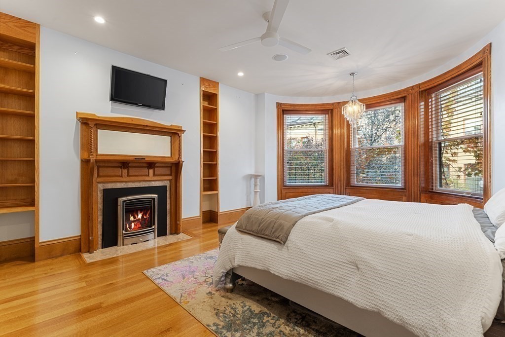 136 St Botolph Street Boston, MA 02115 - Photo 18 of 40 a bedroom with a bed and a fireplace