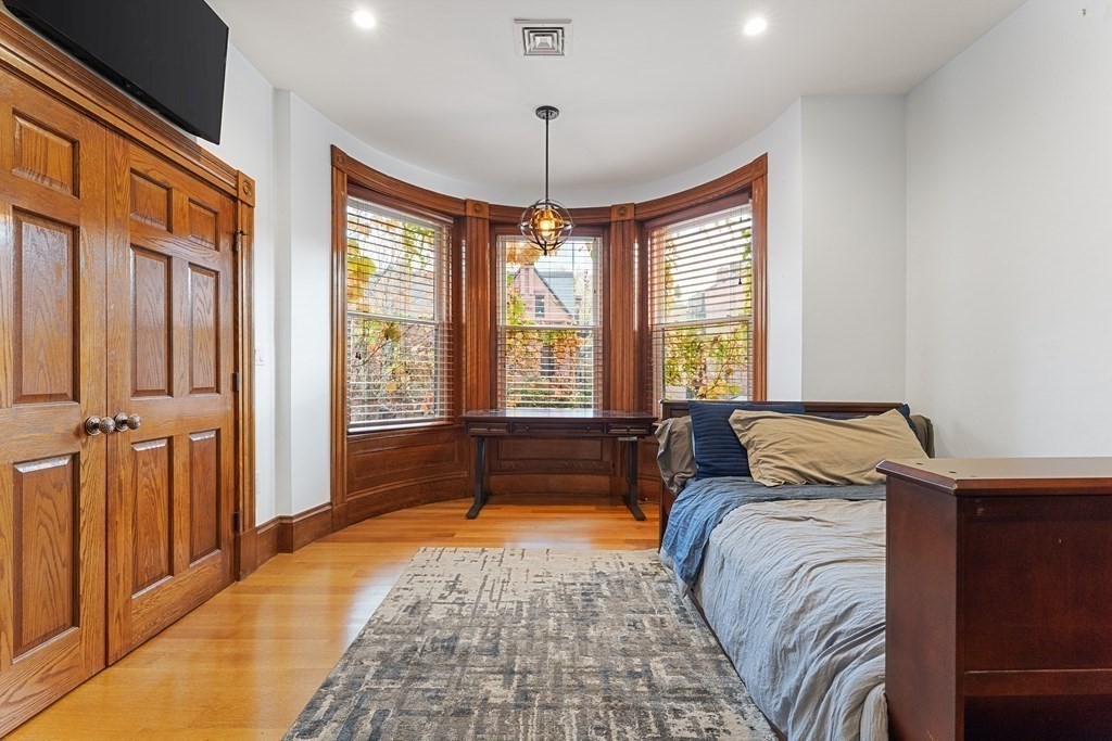 136 St Botolph Street Boston, MA 02115 - Photo 21 of 40 a bedroom with a bed and a window