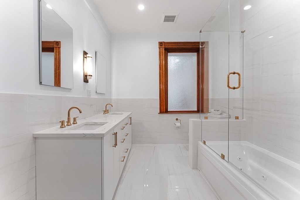 136 St Botolph Street Boston, MA 02115 - Photo 22 of 40 a bathroom with a tub a sink and mirror