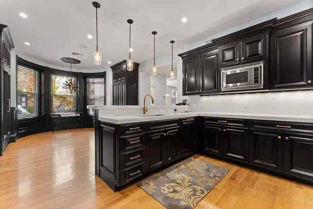 a kitchen with stainless steel appliances granite countertop cabinets a refrigerator and a sink