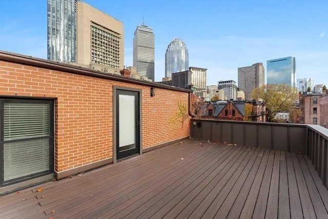 a view of a balcony with wooden floor