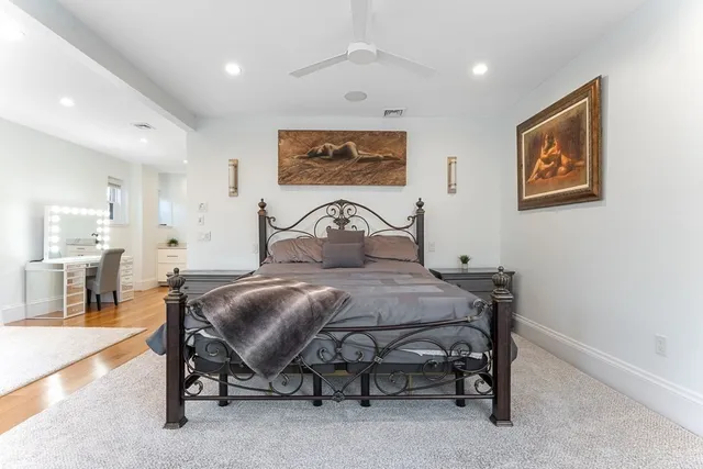 a bedroom with a bed and glass windows