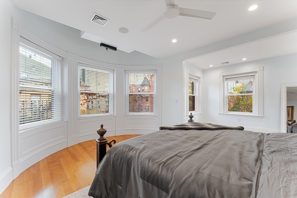 136 St Botolph Street Boston, MA 02115 - Photo 10 of 40 a bed sitting in a spacious bedroom next to a window