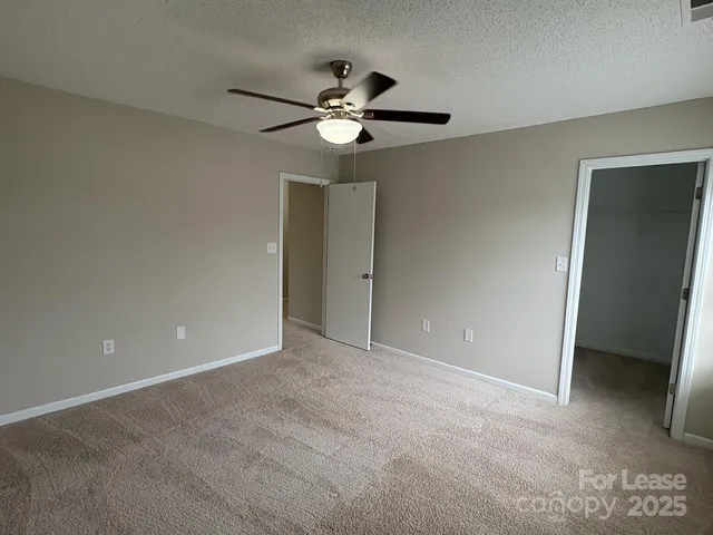 a view of a livingroom with a ceiling fan and window