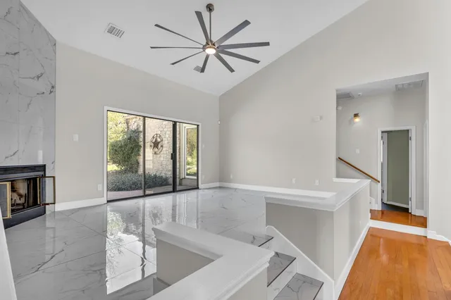 a view of an empty room with a fireplace and a large window