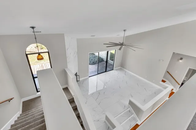 a view of a kitchen with furniture and wooden floor