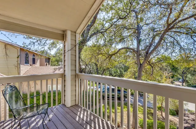a view of a balcony with wooden floor