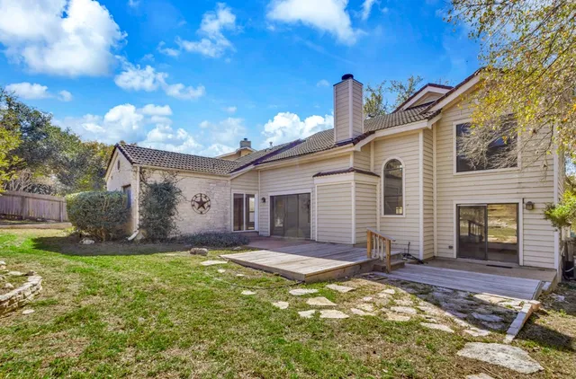 a view of a house with backyard and sitting area