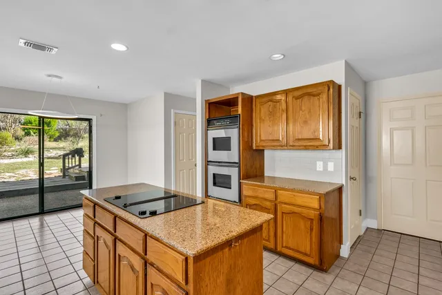 a kitchen that has a cabinets and a stove top oven