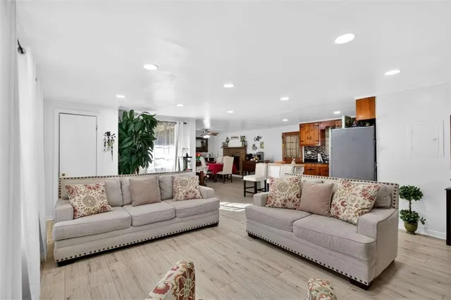 a kitchen with stainless steel appliances granite countertop a refrigerator a sink a stove and island