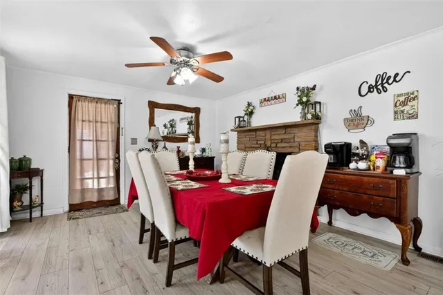 a dining room with furniture a rug and wooden floor