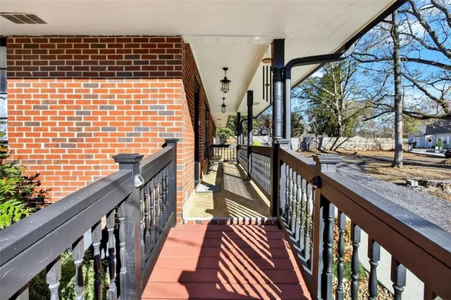 a view of balcony with wooden floor and fence