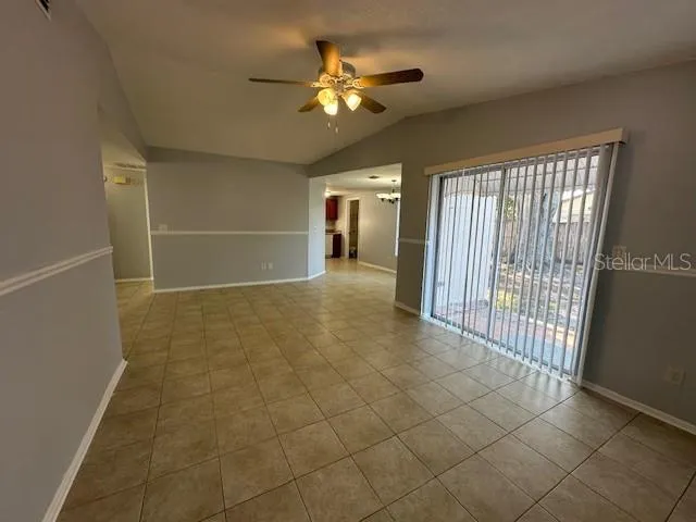 a view of a livingroom with a ceiling fan and window