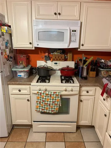 a kitchen with appliances cabinets and a counter top space