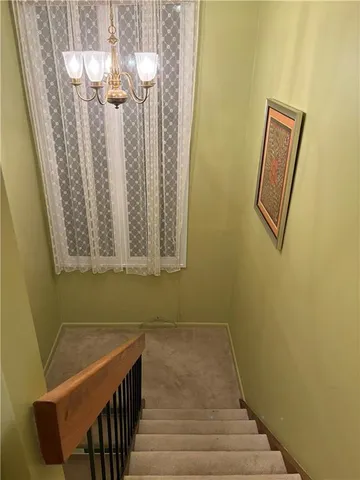 a view of a room with wooden floor and staircase